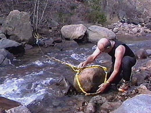 Placing the rope sling on a rock